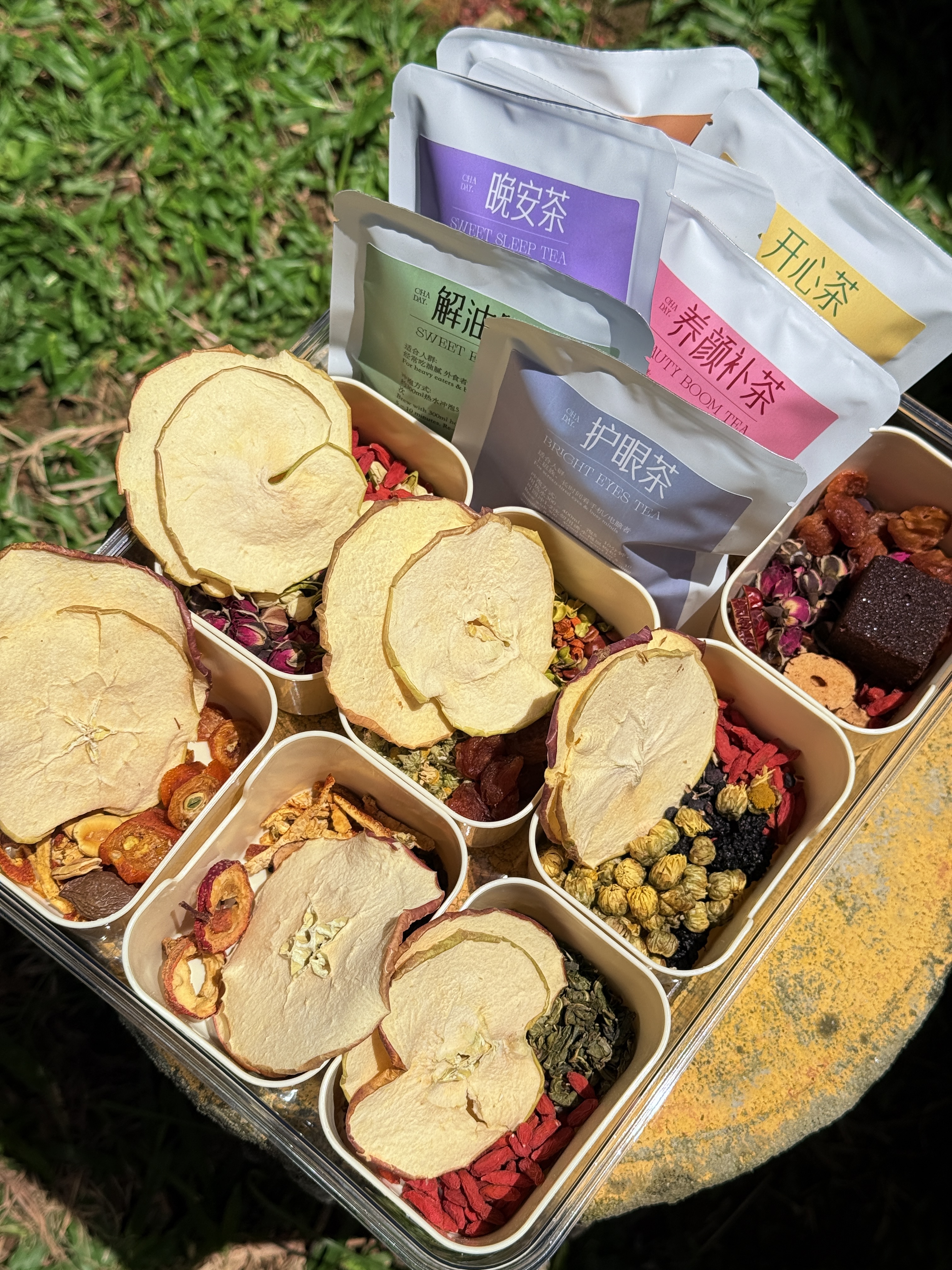 Cha Day tea packets and loose fruit ingredients